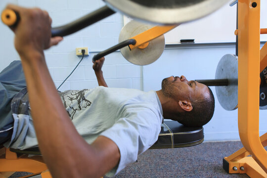 Man who had Spinal Meningitis and can't walk working out on exercise machine