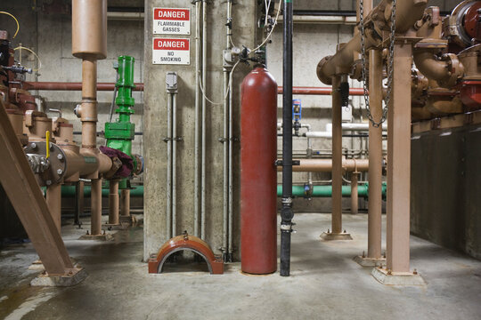 Heavy machinery with compressed gas cylinder in a sewage treatment plant