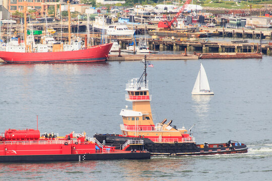Tugboat moving tanker through Boston Harbor
