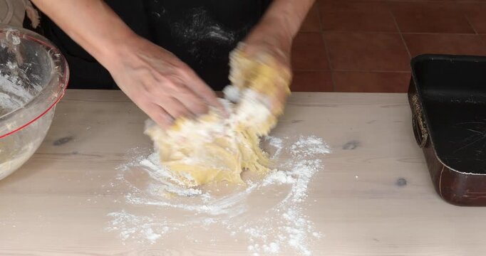 Kneading Soft Dough by Hand After Adding Flour for Homemade Pastry Preparation, Close Up