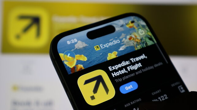 Closeup of a smartphone screen displaying the expedia travel app store page with its logo and download button visible