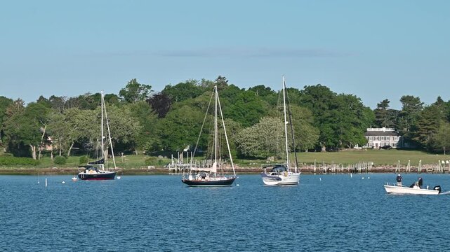Stonington Borough, Connecticut, USA - Fishing Skiff Passing Sailboats in Stonington Harbor