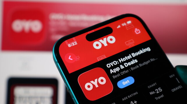 Closeup of a smartphone screen displaying the oyo hotel booking application on the apple app store, showcasing the app icon and download button