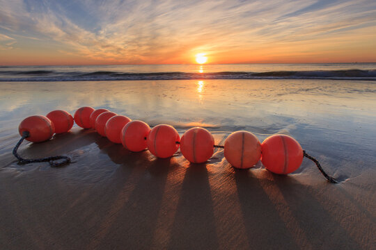 Scalloping buoys on Scotch Beach at sunrise
