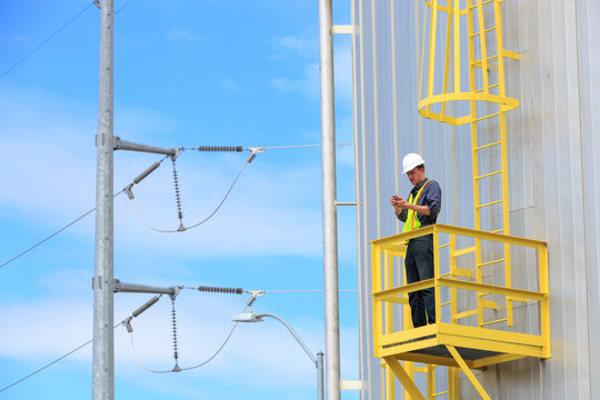 Industrial engineer on platform of a fuel tank at a power plant