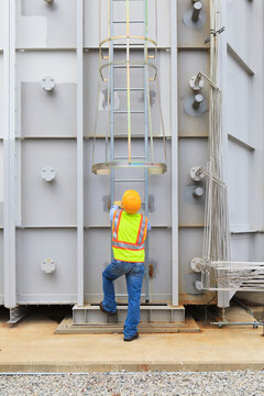Engineer at sound suppression stage of gas turbine which drives generators in power plant