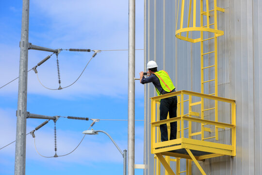 Industrial engineer on platform of a fuel tank at a power plant