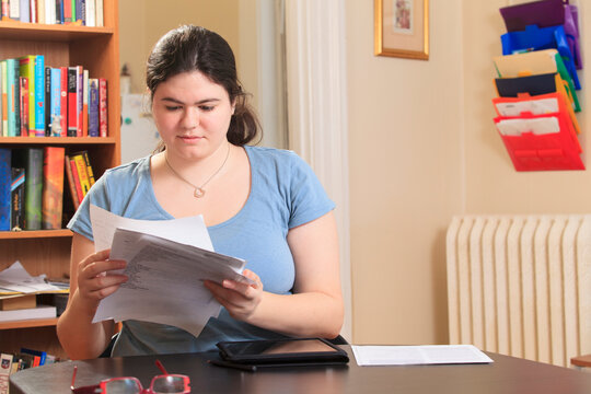 Woman with Asperger syndrome sorting through her job applications