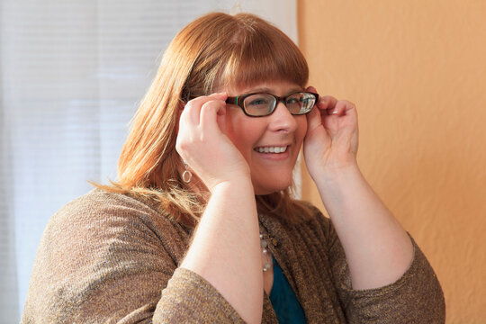Woman who is legally blind trying on her glasses