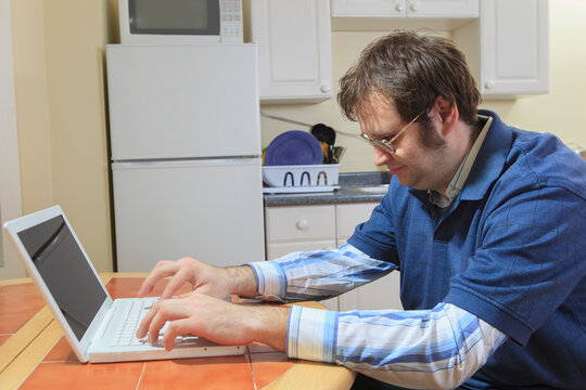 Technology engineer and programmer with Asperger's working on his laptop from home