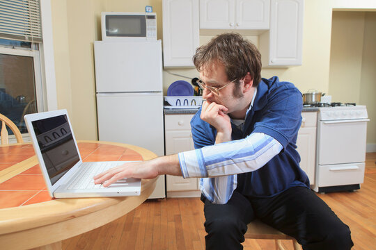 Technology engineer and programmer with Asperger's working on his laptop from home