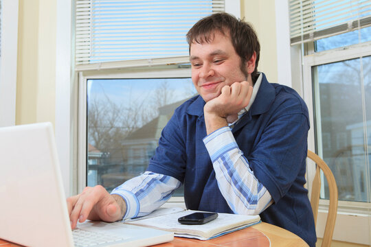 Technology engineer and programmer with Asperger's working on his computer from home