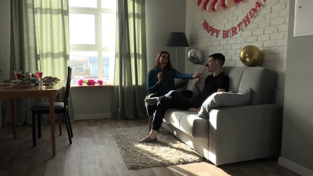 Mother and son fool around trying on decorative smiles