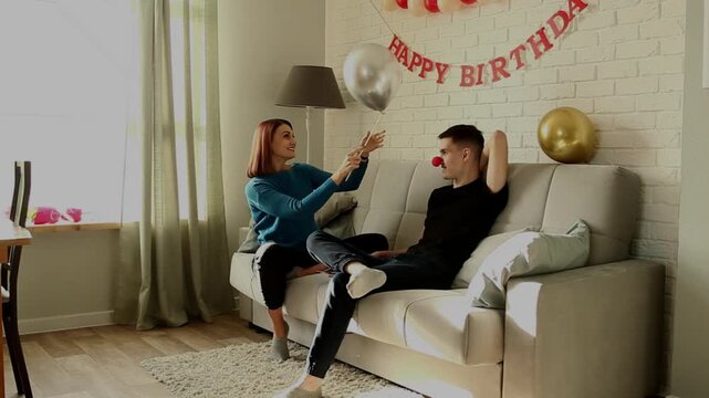 Mother plays with her son with a balloon