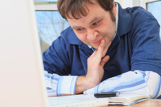 Technology engineer and programmer with Asperger's working on his computer from home