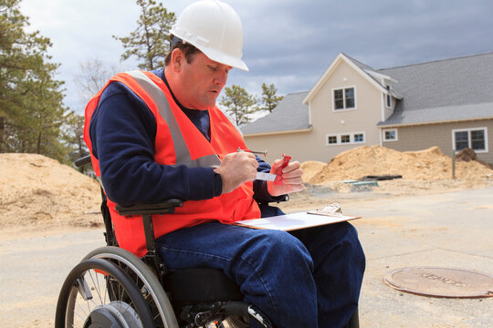Construction engineer with spinal cord injury adjusting vise tool on site