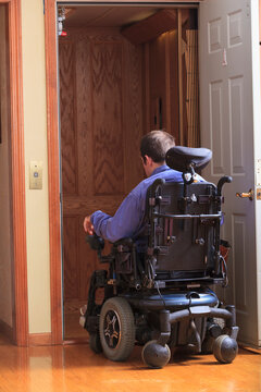 Man with Cerebral Palsy entering a home elevator