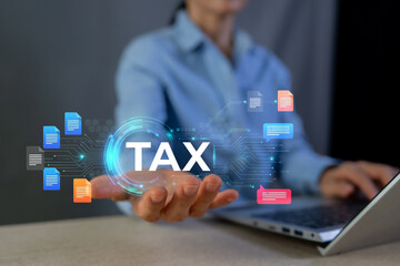 Fototapeta premium Businesswoman holding TAX icon for online financial return and digital document management.