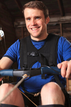 Man with spinal cord injury using his rowing machine