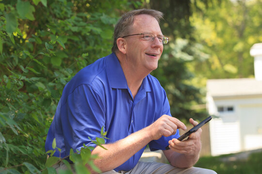 Man with Cerebral Palsy and dyslexia using his tablet