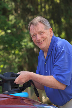 Man with Cerebral Palsy and dyslexia buffing his car