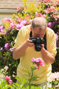 Man with Cerebral Palsy and dyslexia photographing his flowers