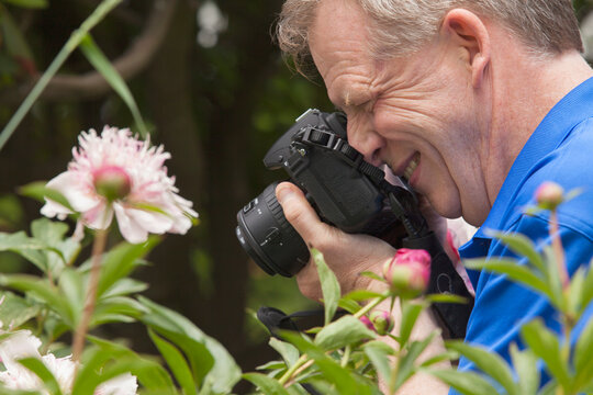Man with Cerebral Palsy and dyslexia photographing his flowers