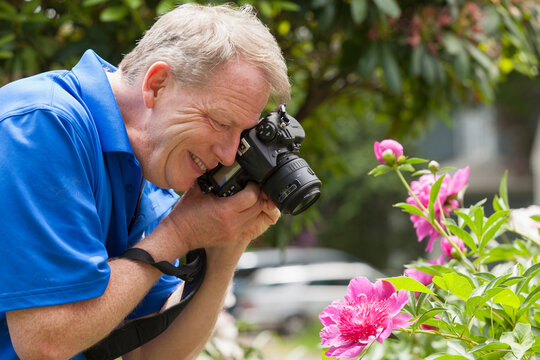 Man with Cerebral Palsy and dyslexia photographing his flowers