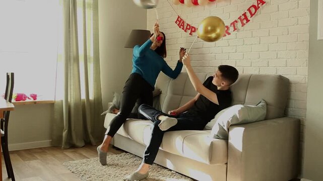 Mother and son fighting with balloons