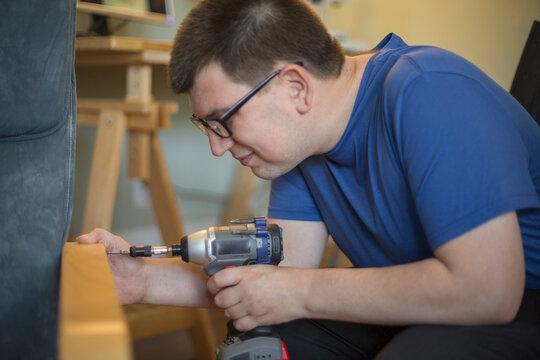 Man with Visual Impairment using a drill