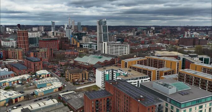 Aerial drone footage of Bridgewater Place and the Leeds city centre skyline in West Yorkshire England showing modern residential developments commercial buildings and urban regeneration