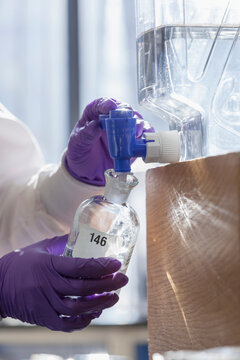 Lab chemist collecting reagent