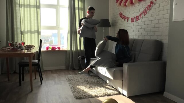 Mother and son fighting with pillows
