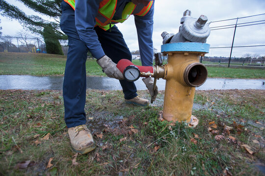 Water department technician removing flushing adapter