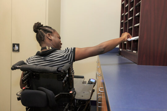 Teen with Cerebral Palsy using mailbox