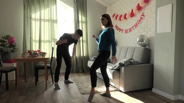 Mother and son dancing a fast dance