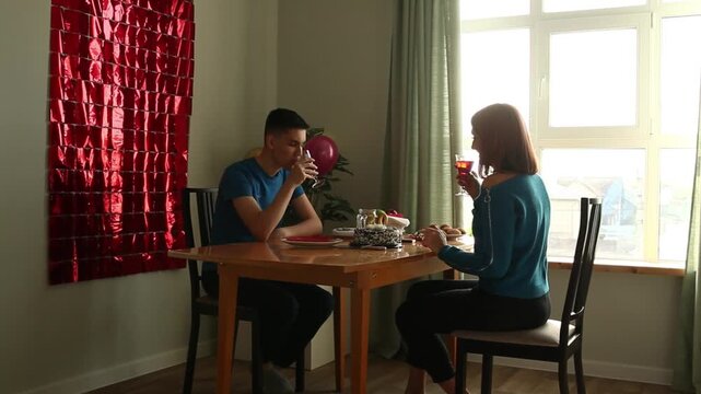 Son and mother drink from glasses