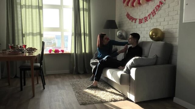 Mother and son hugging on the sofa