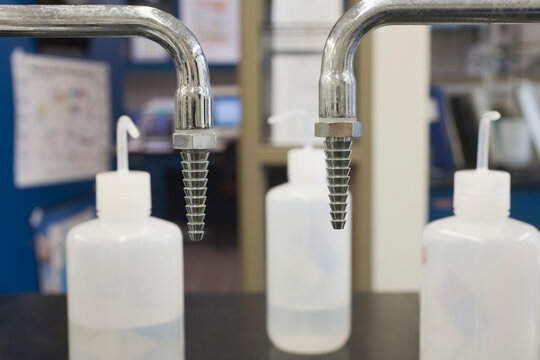 Plastic rinse bottles with faucets in a laboratory