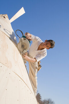 Carpenter working on the turret of a house