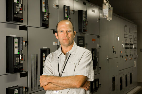Portrait of man standing at laboratory machinery