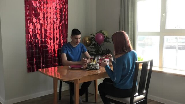 Mother ignites candles on cake