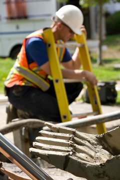 Worker at backhoe on construction site