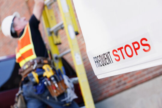 Lineman climbing a ladder