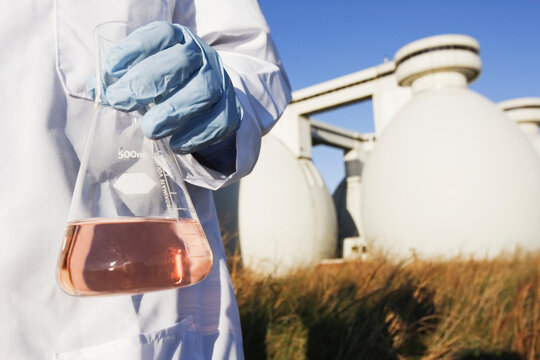 Scientist holding a flask of water sample