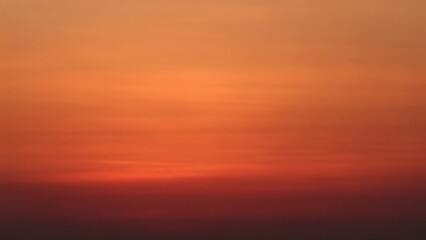 Fototapeta premium Vibrant orange and red sunset sky gradient creating a warm serene tranquil background perfect for abstract designs meditation apps peaceful nature themes breathtaking sunrise colors artistic
