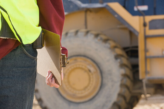 Engineer holding a clipboard at a construction site