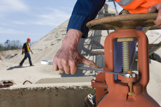 Engineer turning bolt of a valve