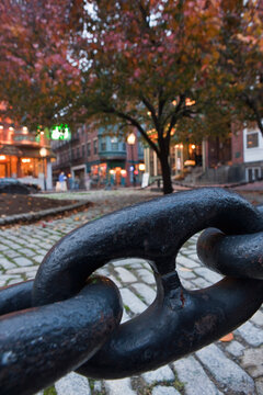 Close-up of a metal chain with buildings in the background, North Square