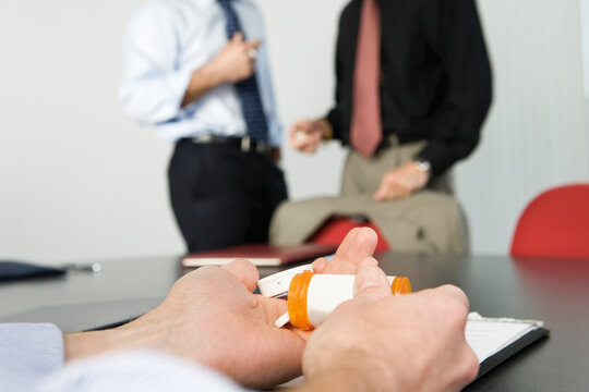 View of a businessman with drugs in the office
